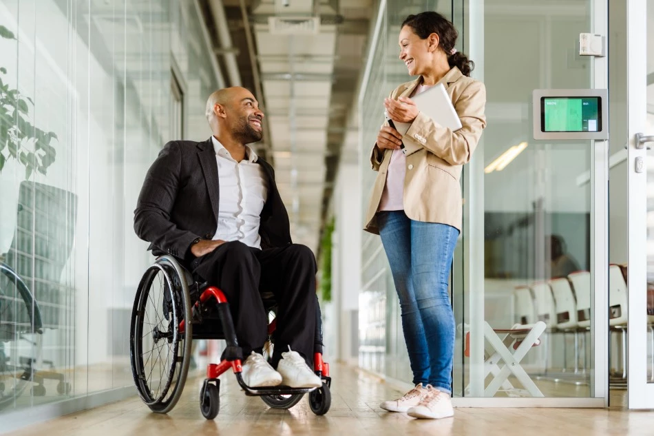 Disabled man in wheelchair talking with support coordinator